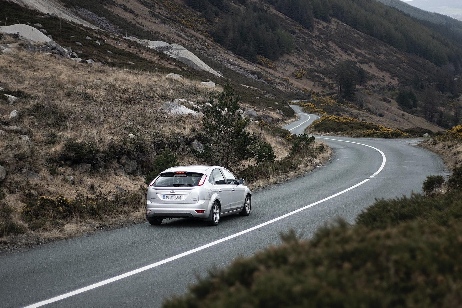 car driving down road